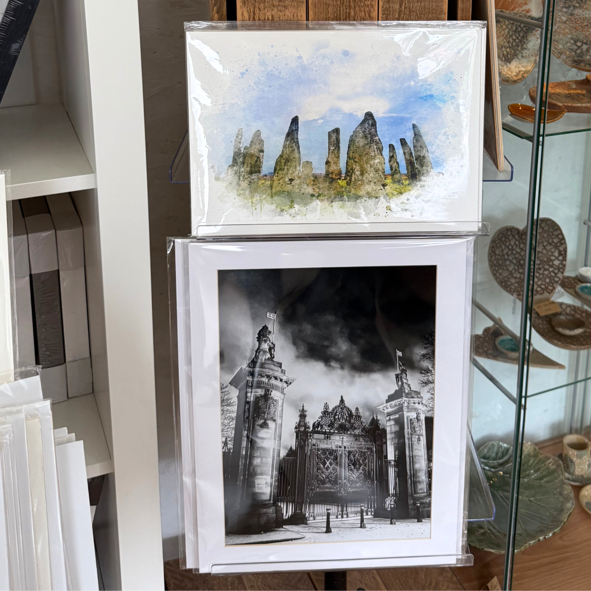 Artwork displayed in clear CelloBag.co.uk cello bags in a print shop setting