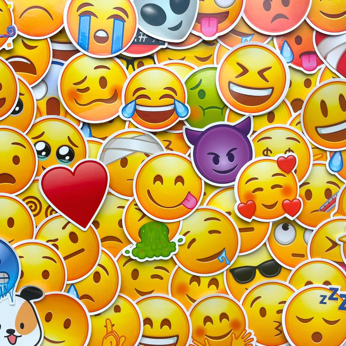 Close-up of large emoji stickers with varied facial expressions