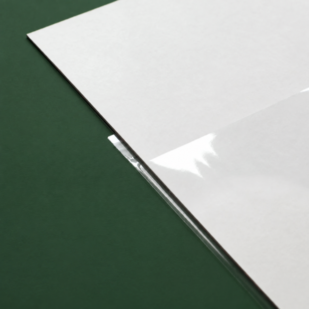 Close-up of a clear 40 micron OPP cello bag edge from CelloBag.co.uk over an art print